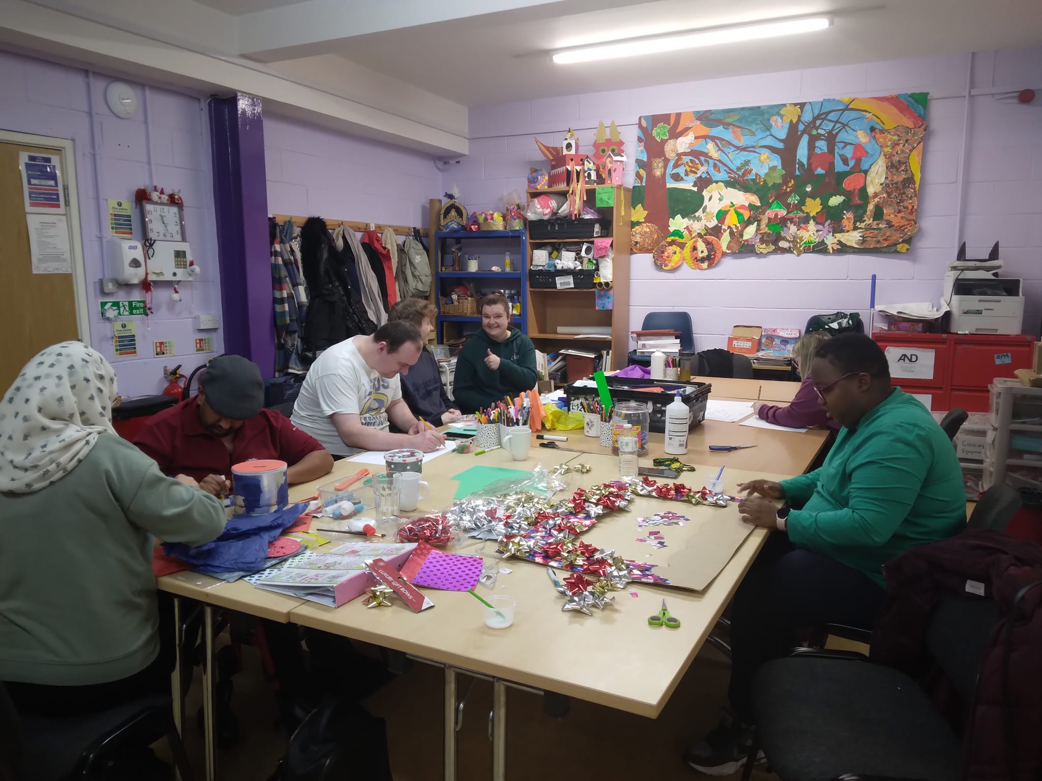 A picture of some of our members sat at a table. They are making things for our Winter Fayre.